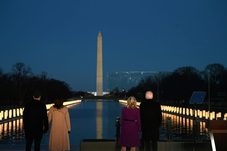 President-elect Joe Biden (R) and incoming First Lady Jill Biden watch as a Covid-19 memorial is lit in Washington, DC