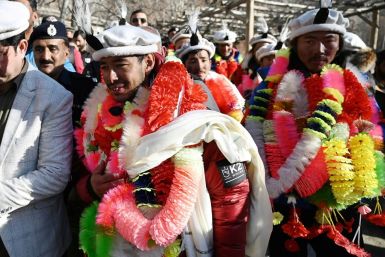 Nepali climbers Nirmal Purja and Mingma Sherpa are festooned with garlands on their arrival in Shigar district after conquering K2