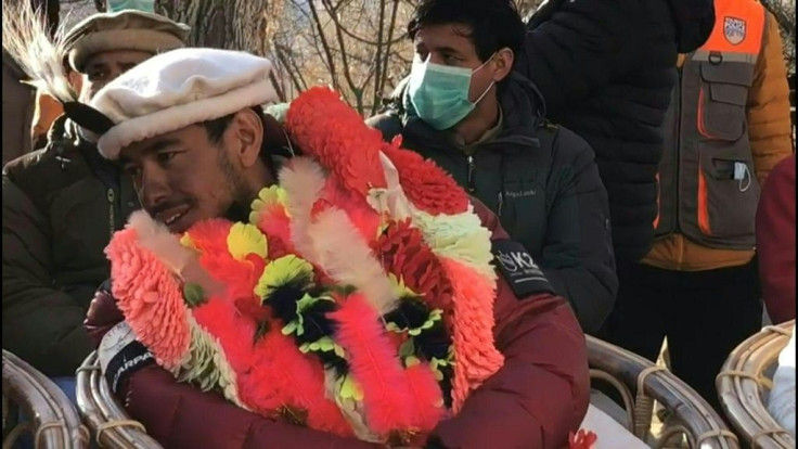 The Nepali team which made history at the weekend by becoming the first to summit K2 in winter receive a hero's welcome, with garlands and cake, from the climbing community and others in the Pakistani town of Shigar.