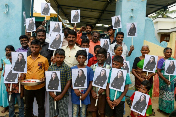 Children waved pictures of their hero in the streets