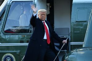 US President Donald Trump waves as he boards Marine One to depart the White House for the final time on January 20, 2021