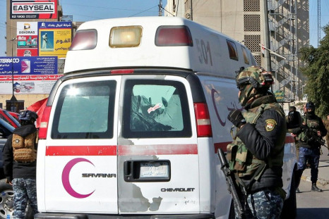 Iraqi security forces at the scene of Thursday's twin suicide bombing