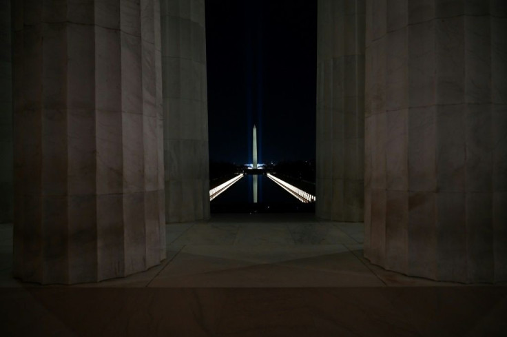 The Reflecting Pool is lit during a Covid-19 Memorial in front of the Washington Monument as seen from the Lincoln Memorial in Washington, DC, during the "Celebrating America" inaugural program for Joe Biden and Kamala Harris on January 20, 2021