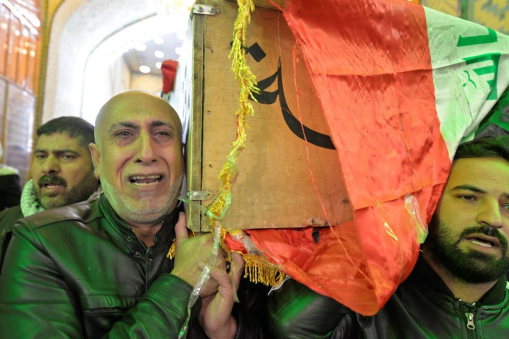 Iraqi mourners in Najaf carry the coffin of a victim killed in a twin suicide bombing in central Baghdad