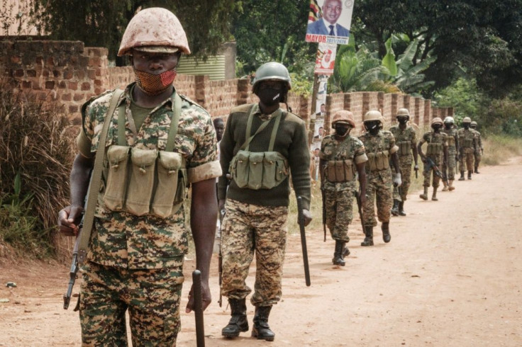 Soldiers pictured on patrol near Bobi Wine's home in Magere, on the outskirts of Kampala, where he has confined since the election