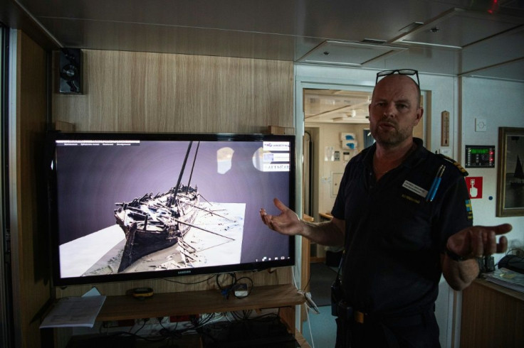 Patrik Dahlberg, an officer in the Swedish coastguard, briefs his officers before they carry out a dive on a 17th-century shipwreck in the Stockholm archipelago near the town of Dalaro