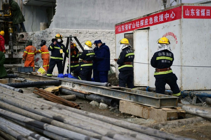 A rescue team works on retrieving 22 miners trapped underground in eastern China's Shandong province