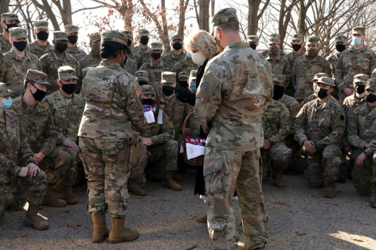 First lady Jill Biden talks with members of the National Guard, after surprising them with chocolate chip cookies and posing for photos outside the Capitol on January 22, 2021, in Washington, DC