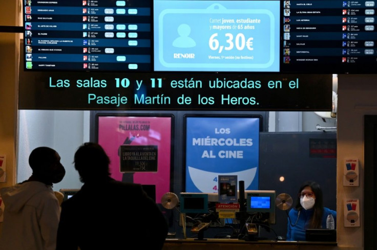 People arrive to see a movie at the Renoir theatre in Madrid on January 8.