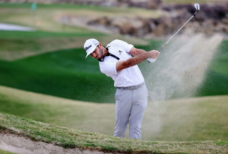 Max Homa blasts out of a bunker on the 18th hole during the third round of The American Express tournament at PGA West in La Quinta, California