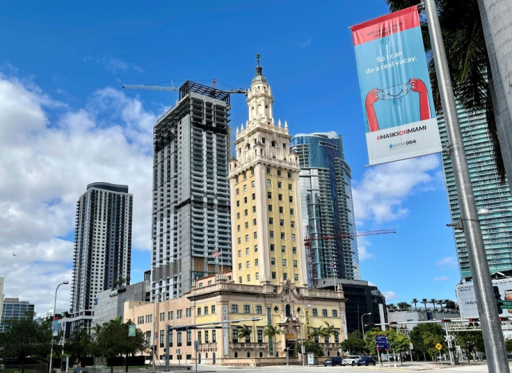 This file photo from December 23, 2020, shows a sign urging Miamians to wear masks against the coronavirus; the southern city has an advantage over northern locales like New York: the balmy climate facilitates outdoor meetings