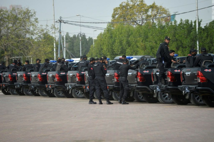 Armed police form a tight security cordon outside the National Stadium while the Pakistan and South Africa cricket teams train inside ahead of the first Test beginning Tuesday