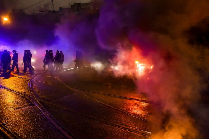 A flare thrown by protesters burns near Moscow's penal detention centre Number 1 where opposition leader Alexei Navalny is being held