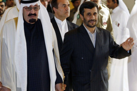 Iran's President Ahmadinejad walks hand-in-hand with Saudi Arabia King Abdullah as they arrive for the opening of GCC summit in Doha