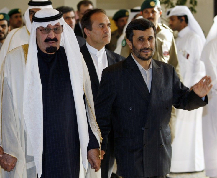 Iran's President Ahmadinejad walks hand-in-hand with Saudi Arabia King Abdullah as they arrive for the opening of GCC summit in Doha