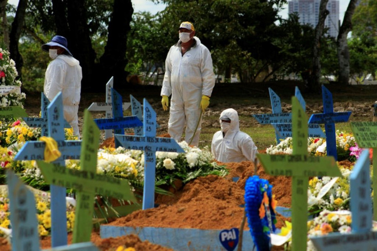Gravediggers pictured during a funeral of a COVID-19 victim at the Nossa Senhora Aparecida cemetery in Manaus, Amazonas state, Brazil