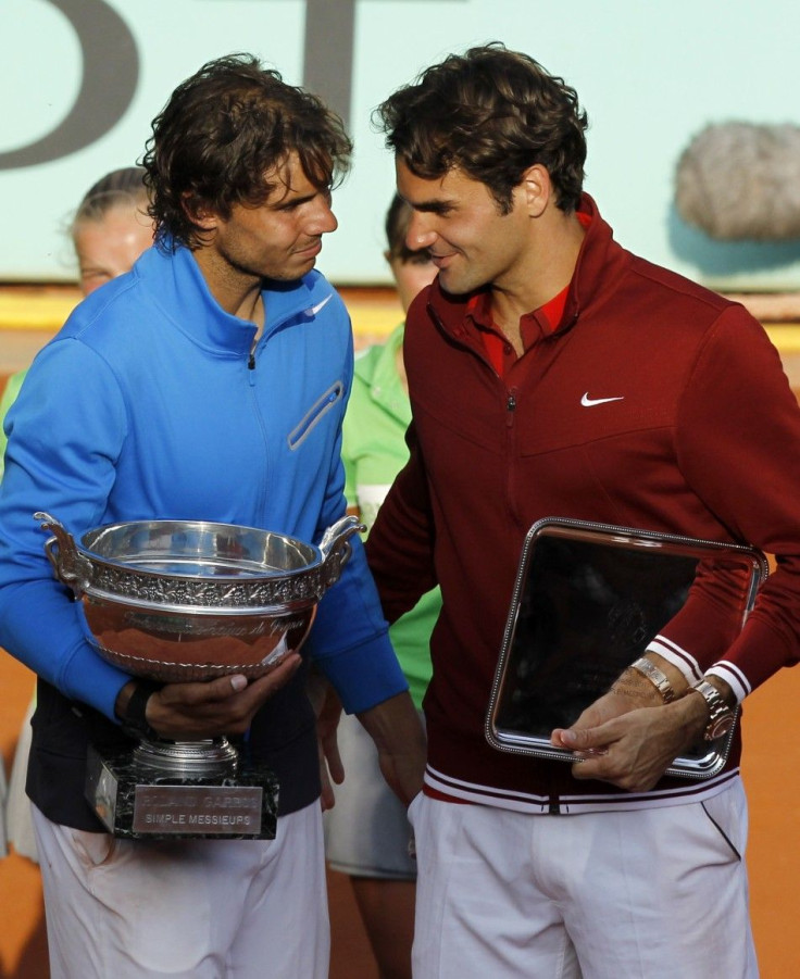 Nadal of Spain and Federer of Switzerland pose with their trophies after their men's final at the French Open tennis tournament at the French Open tennis tournament at the Roland Garros stadium in Paris.