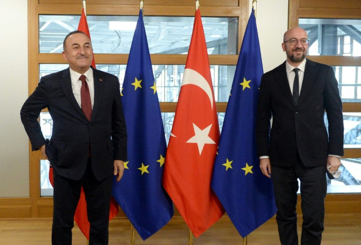 Turkish Foreign Minister Mevlut Cavusoglu (L) is welcomed by European Council President Charles Michel before their meeting in Brussels on Friday. Turkey's EU accession talks have been stalled for years