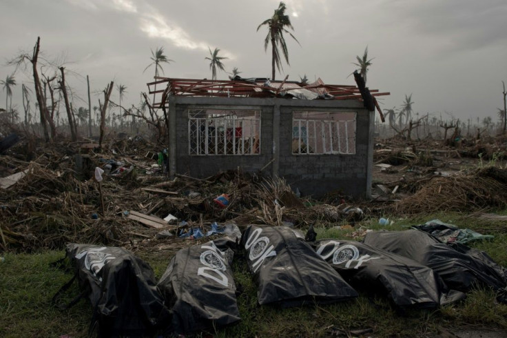 The bodies of five victims of typhoon Haiyan lie in front of a damaged house in Tanauan on November 20, 2013 in the Philippines