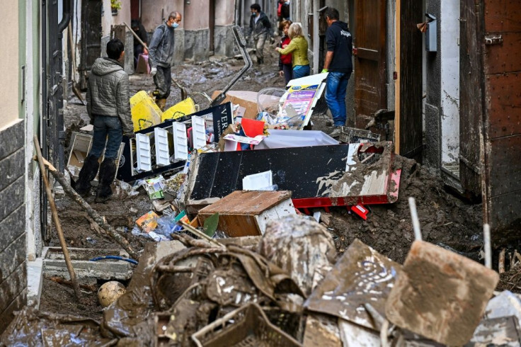 Residents clear their house following a mudslide on October 4, 2020 in Garessio, Piedmont, after storms lashed the region
