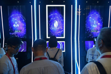 People have their faces scanned as they arrive for the opening ceremony of the World Artificial Intelligence Conference (WAIC) in Shanghai on August 29, 2019