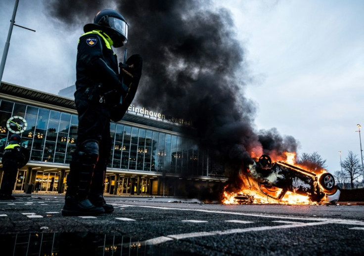 A car was torched outside Eindhoven's central train station where businesses were also looted