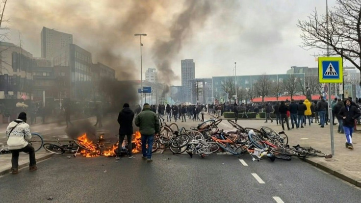 Police use tear gas and protesters throw rocks in the Dutch city of Eindhoven after a demonstration against a new curfew to curb the spread of Covid-19 in the Netherlands degenerated into clashes.