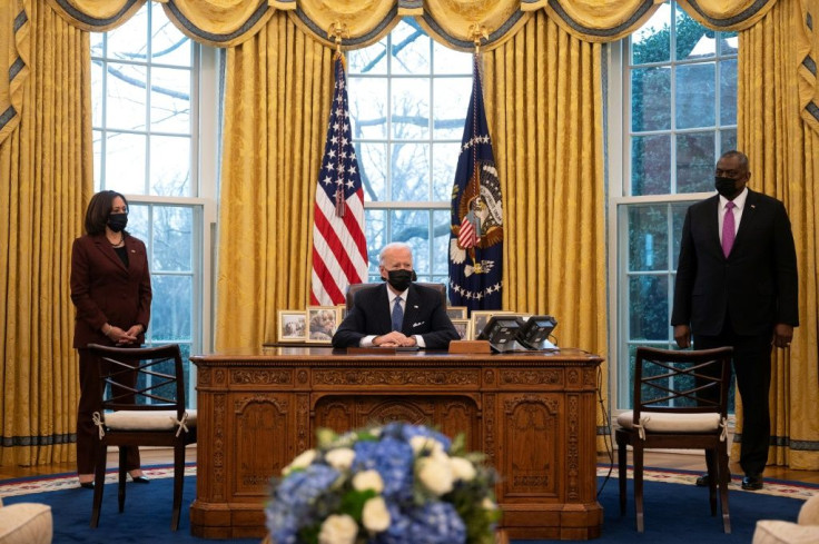 Newly appointed Defense Secretary Lloyd Austin (R), pictured with Joe Biden and Vice President Kamala Harris (L), said he supports the US president's order to lift restrictions on transgender people serving in the military