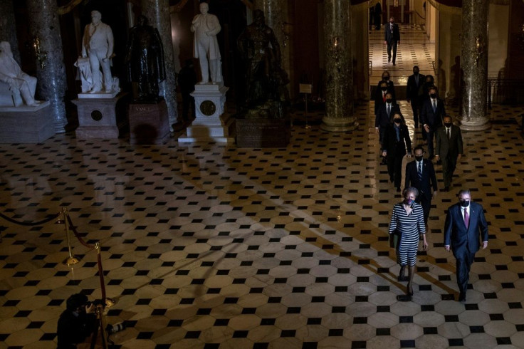 House impeachement managers walk through the Capitol's Statuary Hall to deliver the article of impeachment against Donald Trump to the Senate