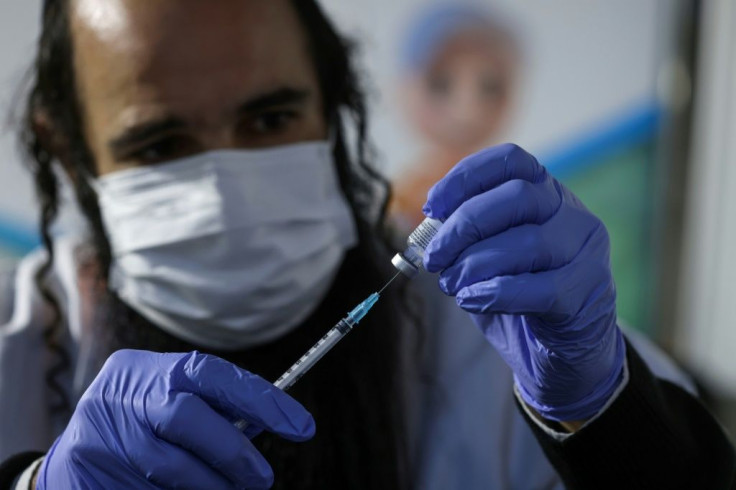 An Israeli health worker prepared a dose of the Pfizer-BioNTech Covid-19 vaccine at Clalit Health Services in Jerusalem earlier this month as part of a vaccination campaign considered one of the largest in the world to date