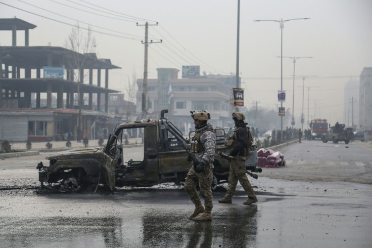 A photo taken on December 20, 2020 shows members of the Afghan security forces at the site of an attack in Kabul. Talks to end Afghanistan's long running war have been marred by an increase in violence from the start