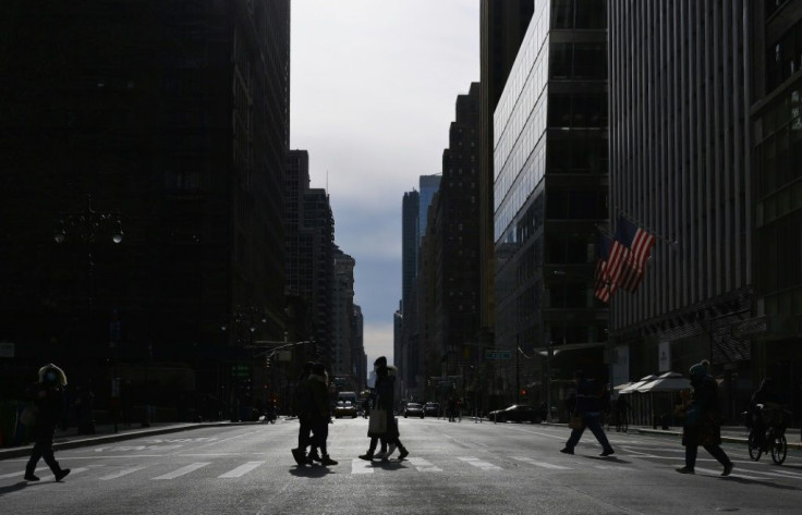People walk through the usually bustling midtown area of Manhattan during lunchtime on January 25, 2021 in New York City