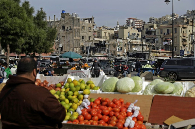 Vendors wait for costumers at a fresh produce market in the Lebanese coastal city of Tripoli, north of Beirut, despite an ongoing lockdown that bans people from food shopping in person