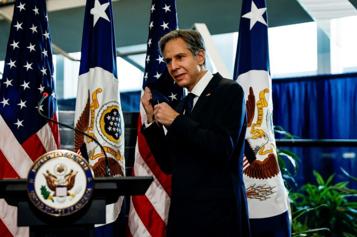 Newly confirmed US Secretary of State Antony Blinken removes his face mask to speak during a welcome ceremony at the State Department in Washington,DC on January 27, 2021