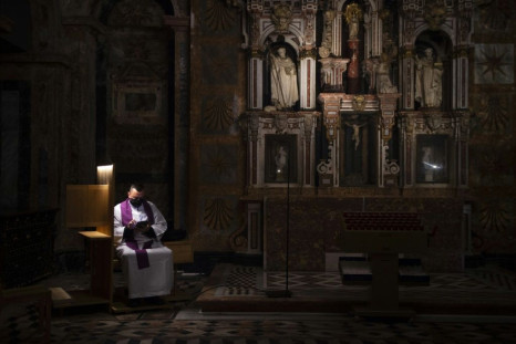 A Spanish priest presides over an empty cathedral as virus cases worldwide topped 100 million