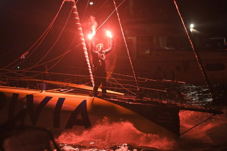 Flare for a finish: French skipper Charlie Dalin sails Apivia across the finish line