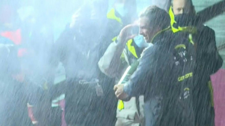 French skipper Charlie Dalin (Apivia) sprays champagne as he sets foot on dry land after becoming the first competitor to cross the finish line in the gruelling Vendee Globe round-the-world race.