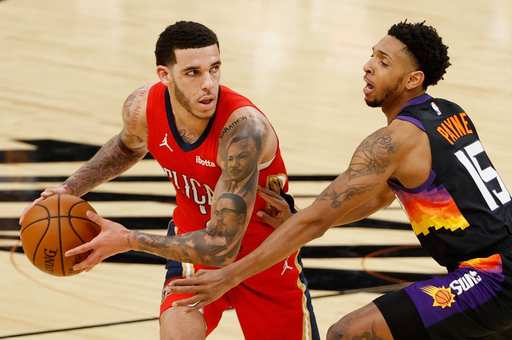 Lonzo Ball #2 of the New Orleans Pelicans looks to pass against Cameron Payne #15 of the Phoenix Suns