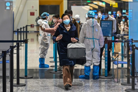 Passengers wear masks at the Tianhe International Airport in Wuhan