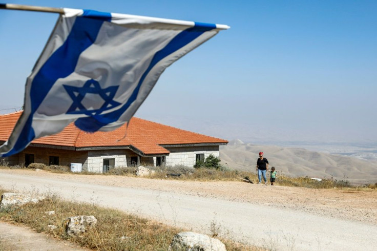 An Israeli flag flies over the wildcat settlement outpost of Givat Arnon, one of 70 the settler lobby is pressing Prime Minister Bejamin Netanyahu to commit to recognising in return for its support