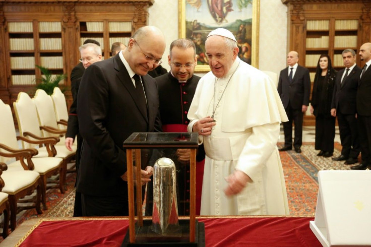 Pope Francis exchanges gifts with Iraqi President Barham Salih at the end of a private audience at the Vatican in January last year