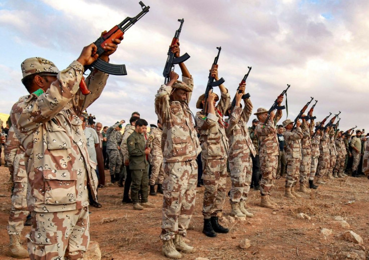 Fighters fire salutatory rounds in the air during a funeral for a commander of the Special Forces of the self-proclaimed Libyan National Army loyal to strongman Khalifa Haftar, in the eastern city of Benghazi on November 1, 2020