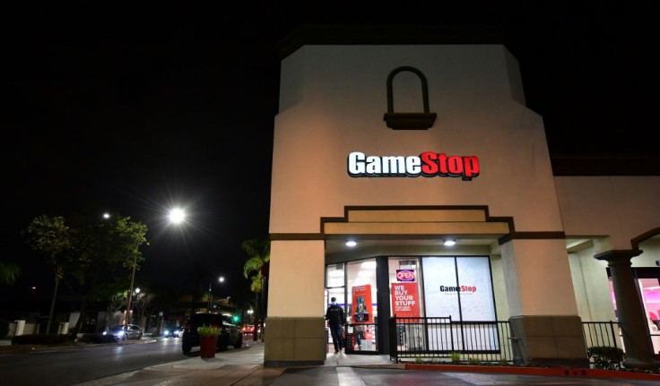 GameStop shares have soared in a clash between a new activist movement and hedge funds
