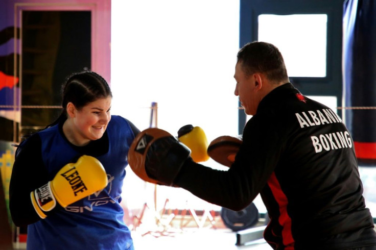 Selaj's coach Jetmir Kuci (R), a nine-time Albanian boxing champion, initially refused to work with her. 'I was a bit traditional,' he recalls