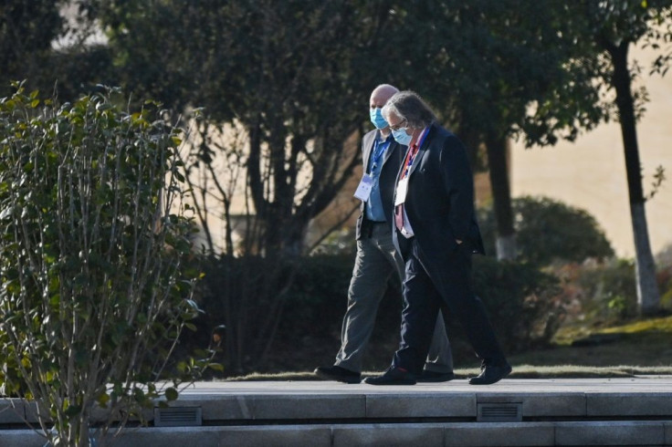 Members of the WHO team in Wuhan walk in the grounds of the Hilton Wuhan Optics Valley Hotel