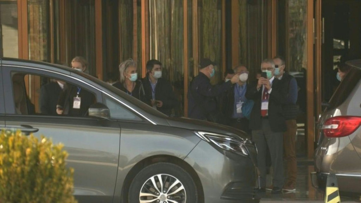 IMAGESWorld Health Organization members are seen getting into cars outside their hotel on Friday. The team of experts is in Wuhan for a coronavirus origins probe.The fieldwork is set to begin in earnest in the afternoon, after being hobbled by delays -