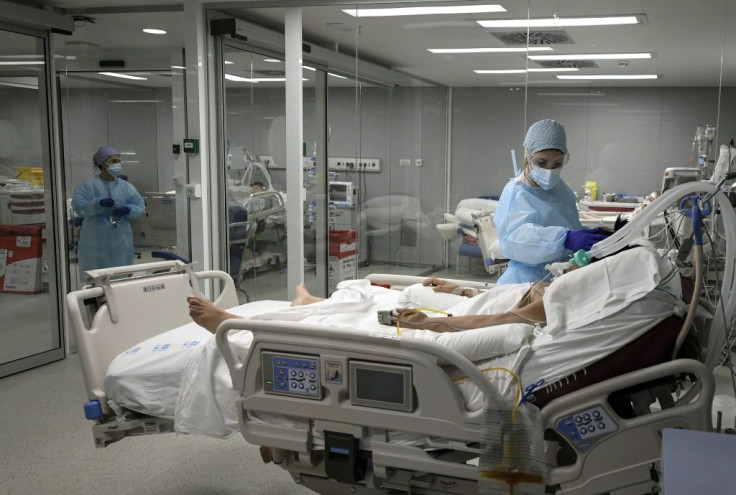 Healthcare workers attend to a patient at the Covid-19 Intermediate Care Unit (IMCU) of the Enfermera Isabel Zendal new emergency hospital, in Madrid, on January 27, 2021