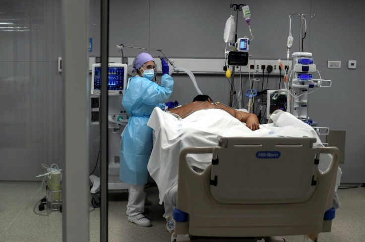 A healthcare worker attends to a patient at the Covid-19 Intermediate Care Unit at the Enfermera Isabel Zendal new emergency hospital in Madrid on January 27, 2021