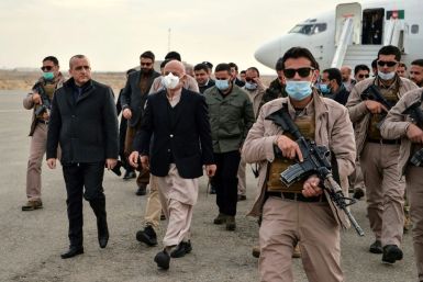 Afghan President Ashraf Ghani (C) arrives with the government delegation during a visit in Herat province
