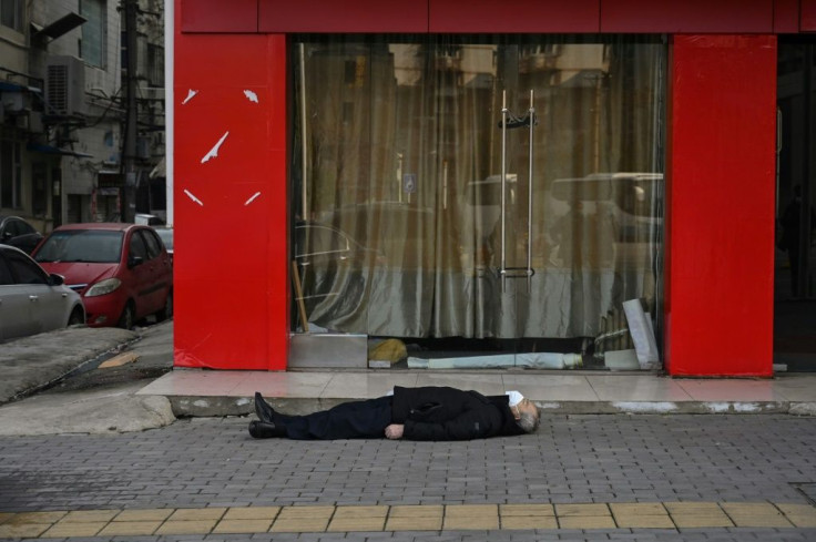 Although the cause of his death has never been established, the unknown man lying on his back has become a morbid symbol of Wuhan submerged by a mysterious killer virus